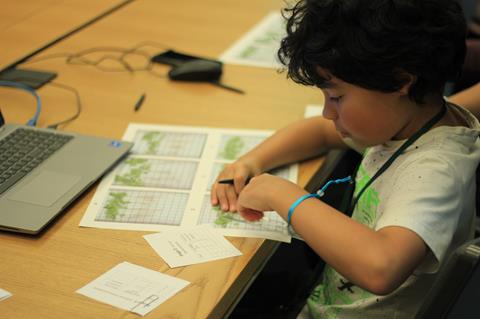 Boy measuring root length when attending the Cambridge Festival 2023