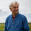 Professor Jorge Dubcovsky standing in a field of wheat