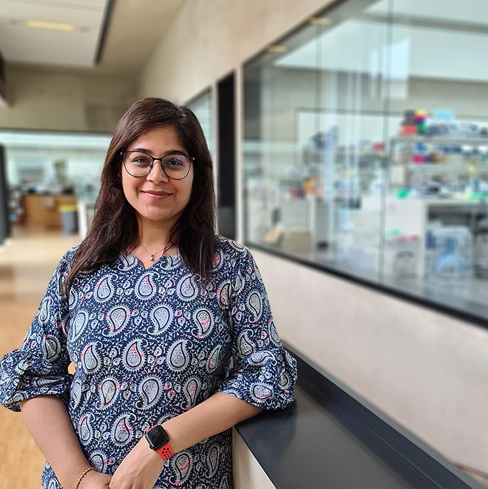 Neha Bhatia pictured in the Sainsbury Laboratory with research labs in background