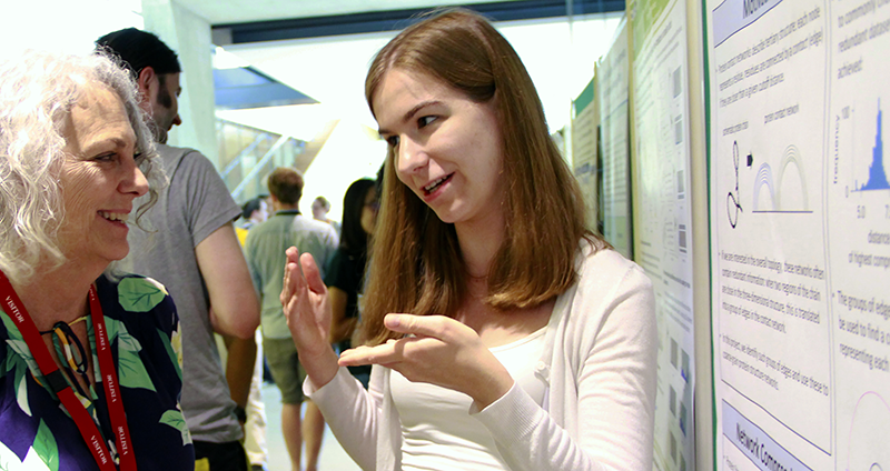 SLCU PhD student Nora Martin discusses her research with SLCU Management Board member Vicki Chandler at the Management Board meeting poster session.