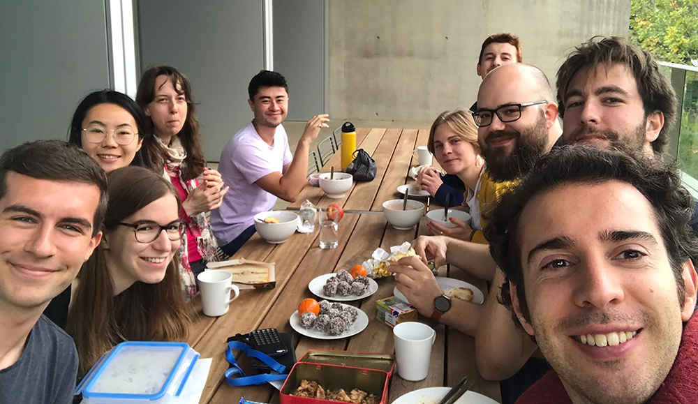 SLCU research students enjoying lunch on the terrace overlooking the Cambridge Botanic Garden.