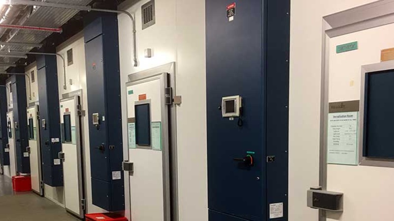 Looking down corridor of walk-in plant growth chambers in the Sainsbury Laboratory