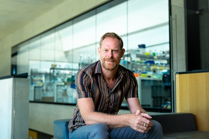 Giles Oldroyd at SLCU with lab area in background