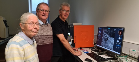 Robin and Linda West, Secretary and Trustee of the charity Rescue Wooden Boats with Trevor Groves at the tabletop scanning electron microscope they are using to examine the different timber.