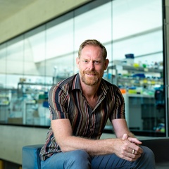 Giles Oldroyd at SLCU with lab area in background