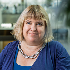 Dr Madelaine Bartlett with Sainsbury Laboratory interior in background