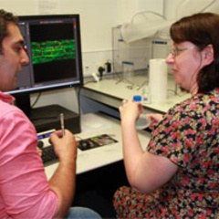 SLCU postdoc Firas Bou Daher showing Biology Teacher Catherine Russell the lab's microscopy facilities.