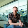 Giles Oldroyd at SLCU with lab area in background