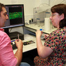 SLCU postdoc Firas Bou Daher showing Biology Teacher Catherine Russell the lab's microscopy facilities.