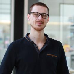 Albin Tuelet pictured in SLCU building with labs in background