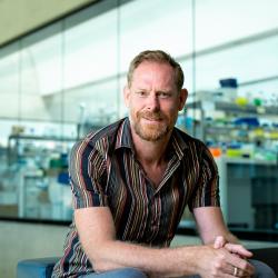 Giles Oldroyd at SLCU with lab area in background