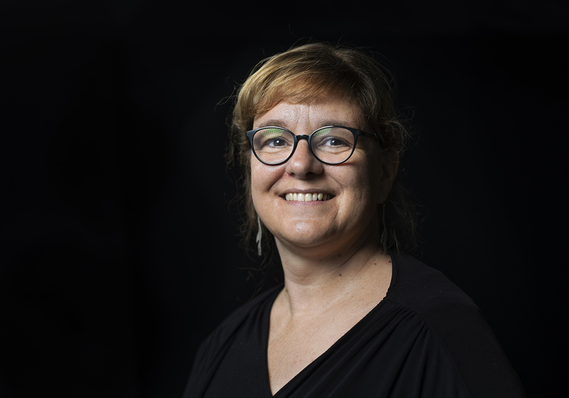 Stéphanie Robert wearing black top with black background