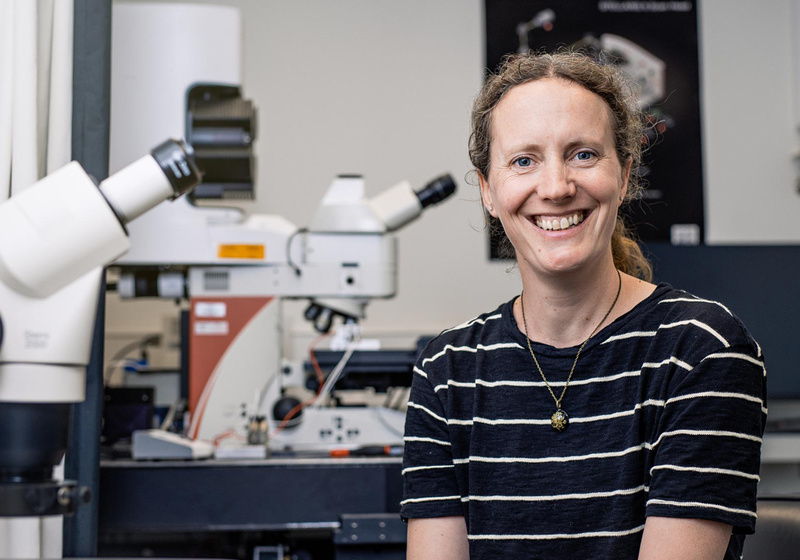 Sarah Robinson pictured with a microscope