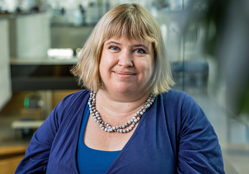 Dr Madelaine Bartlett with Sainsbury Laboratory building interio in background