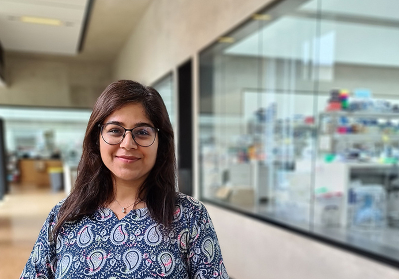 Neha Bhatia pictured in the Sainsbury Laboratory with research labs in background