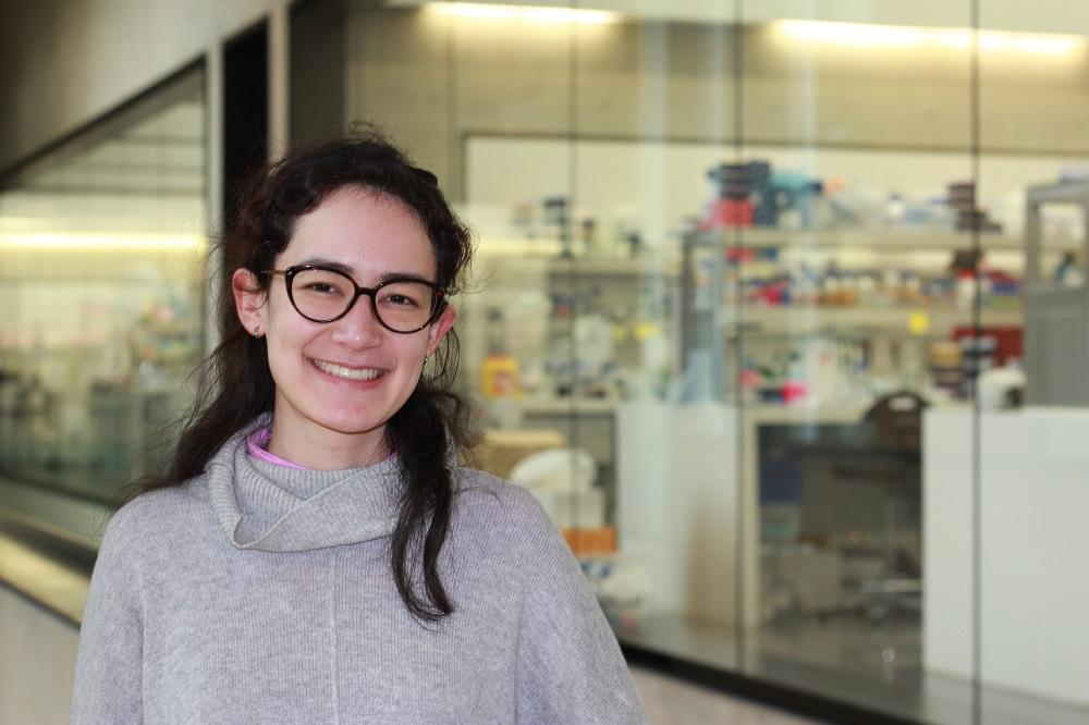 Dr Helen Saville pictured in the SLCU building with laboratory benches in background