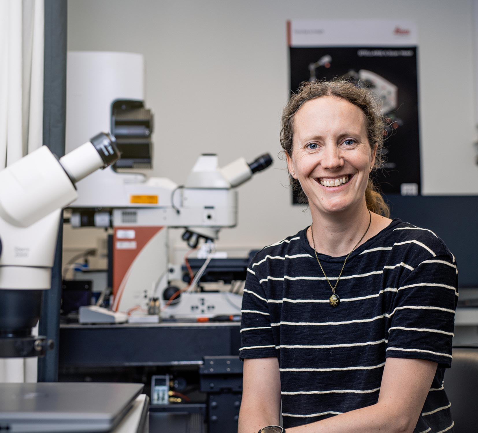 Sarah Robinson pictured with a microscope