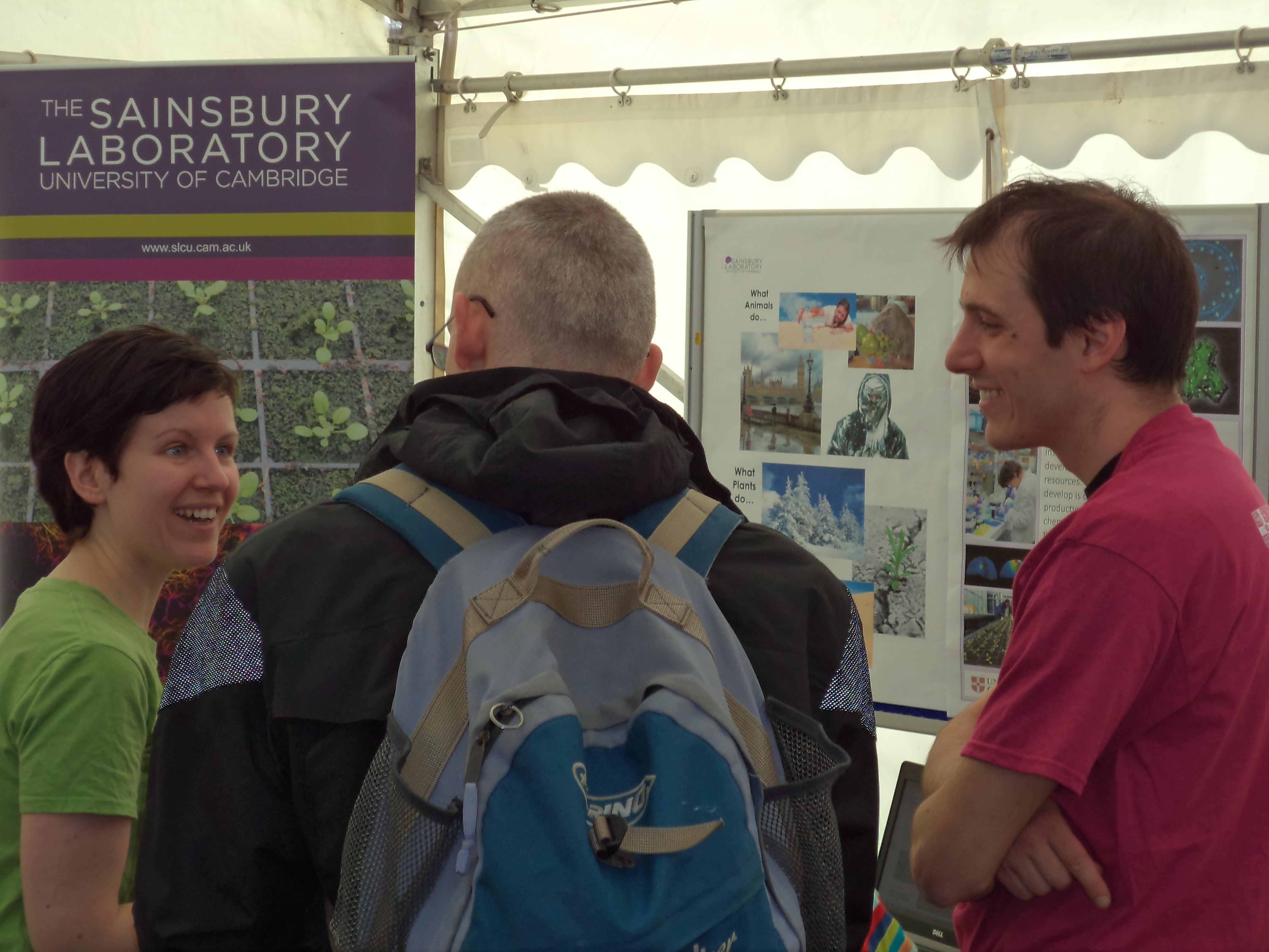 Sainsbury Laboratory postdocs talking with members of the public about plant science. Sainsbury Laboratory postdocs talking with members of the public about plant science.