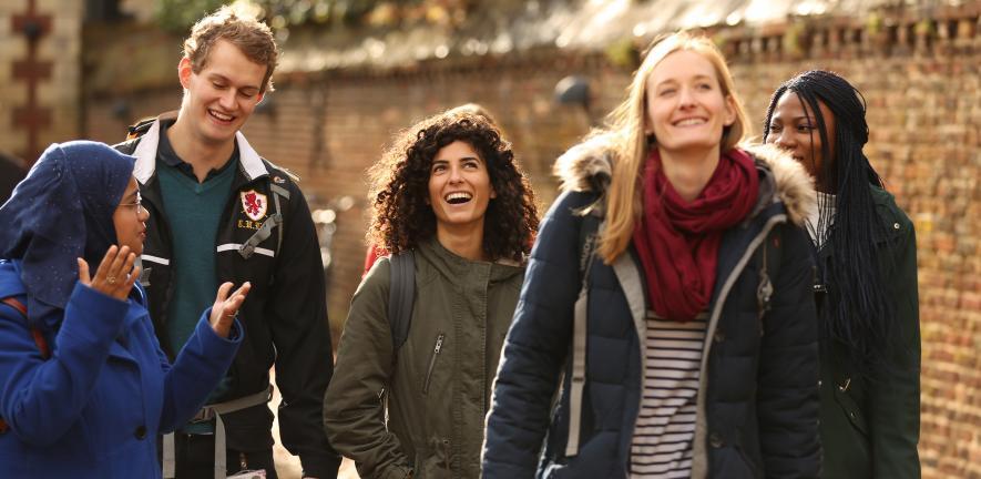 Cambridge postgraduate students walking through Cambridge city. Cambridge postgraduate students walking through Cambridge city.