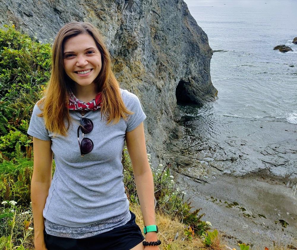 Colleen Drapek pictured on a coastal walk overlooking cliffs and the sea