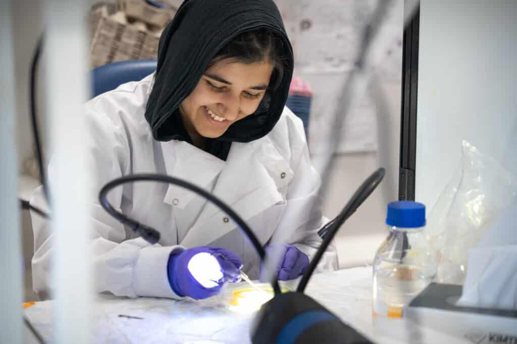 An A-Level Biology student working in a lab 